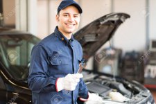 41808176-portrait-of-a-smiling-mechanic-holding-a-wrench-in-his-garage.jpg